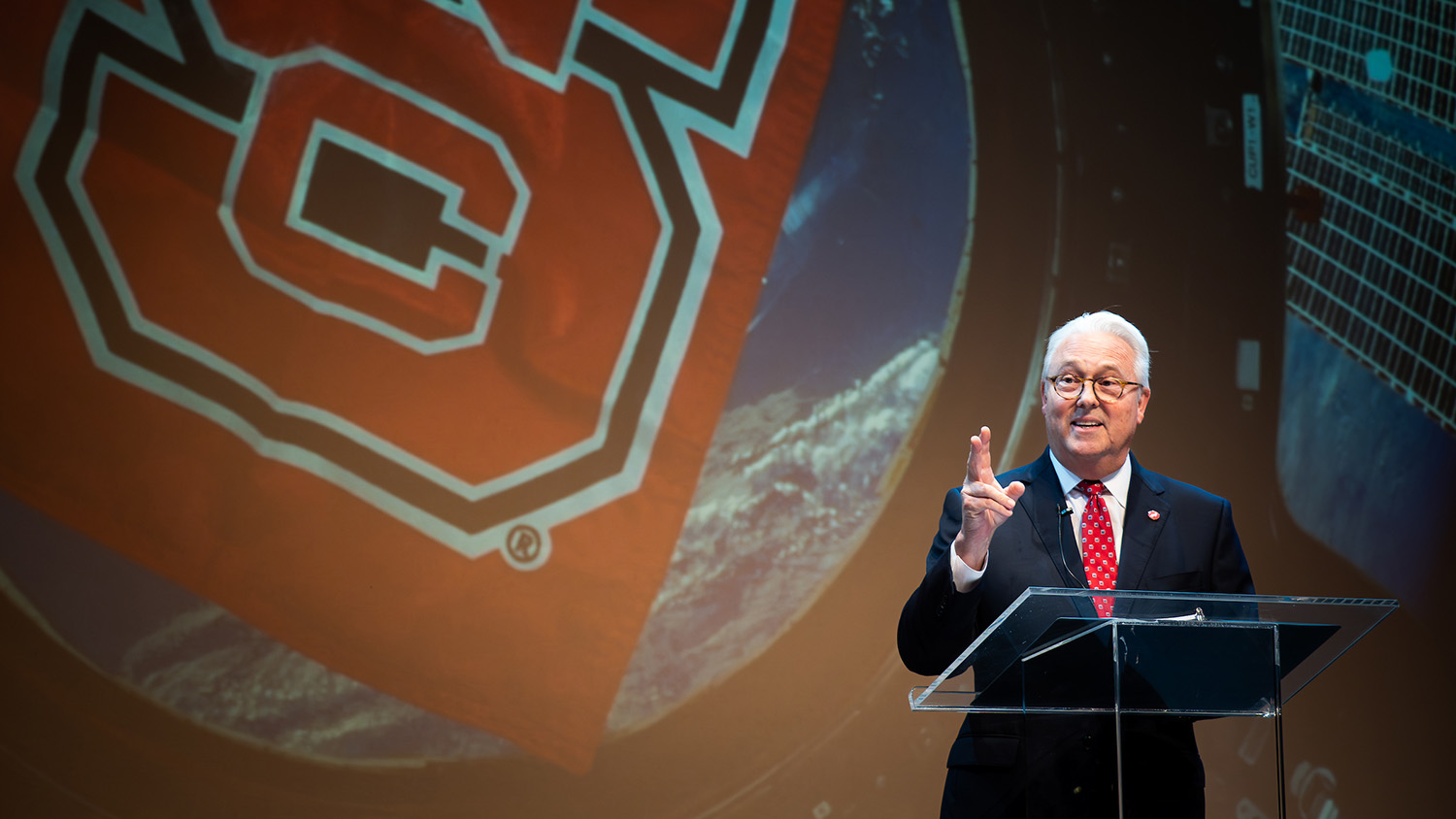 Chancellor Woodson speaks at a podium before the NASA downlink with astronaut alumna Christina Koch.