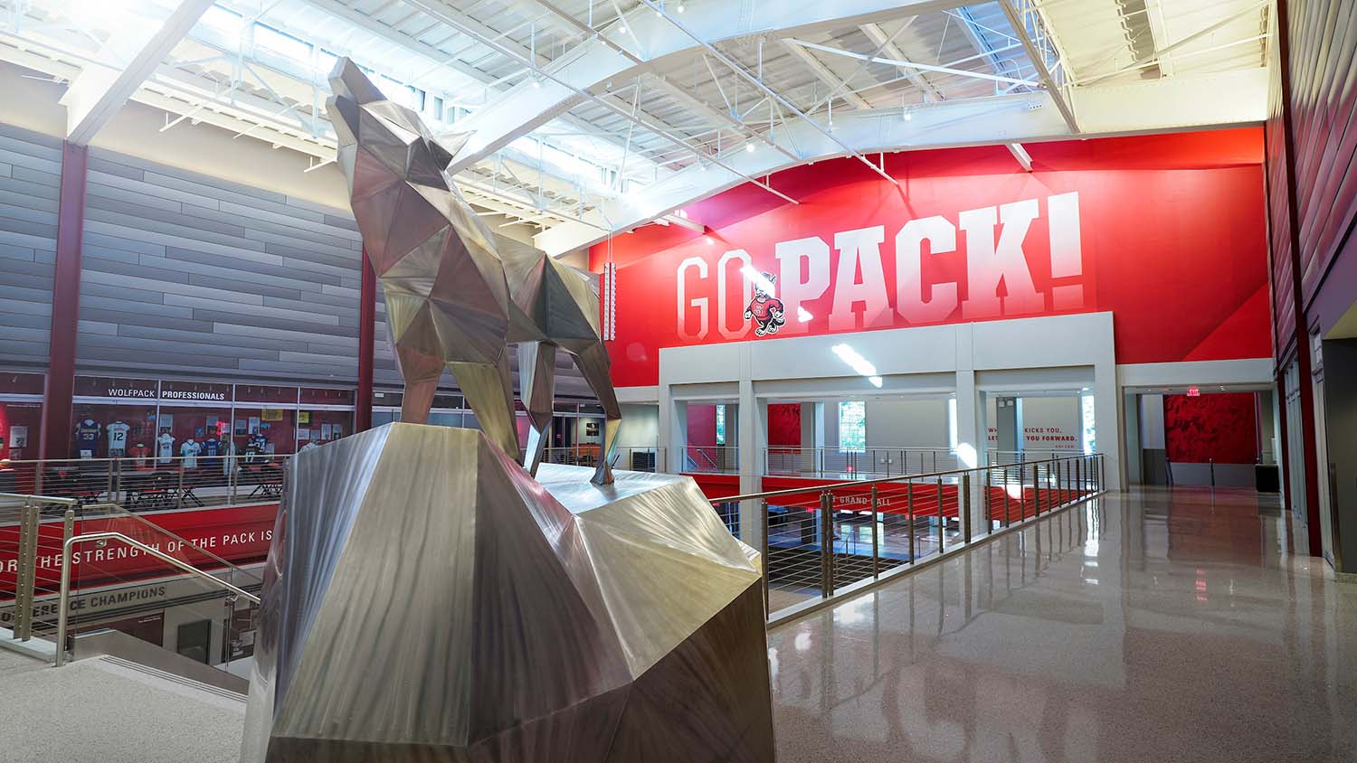 A silver wolf statue in the atrium of the updated Reynolds Coliseum.